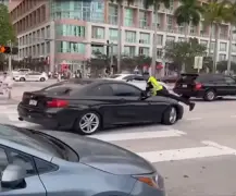 Miami police officer seen clinging to hood of car before shooting driver